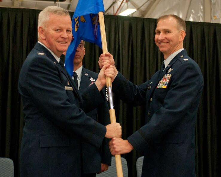 Lt. Col. James P. Ryan accepts the 157th Operations Group guidon from Col. Paul Hutchinson during a change of command ceremony at Pease Air National Guard Base, N.H., Oct. 4, 2014. Ryan replaces Col. Shawn R. Burrus as commander of the 157th Operations Group. (U.S. Air National Guard photo by Staff Sgt. Curtis J. Lenz)