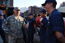 The 111th Attack Wing Command Chief Master Sgt. Paul G. Frisco Jr. talks with local U.S. Coast Guard members during the Fox 29 Salutes the Military Day Sept. 26, 2014, Philadelphia, Pa. The 111th ATKW joined members of each military branch as a show of solidarity during the event. (U.S. Air National Guard photo by Andria J. Allmond/Released)