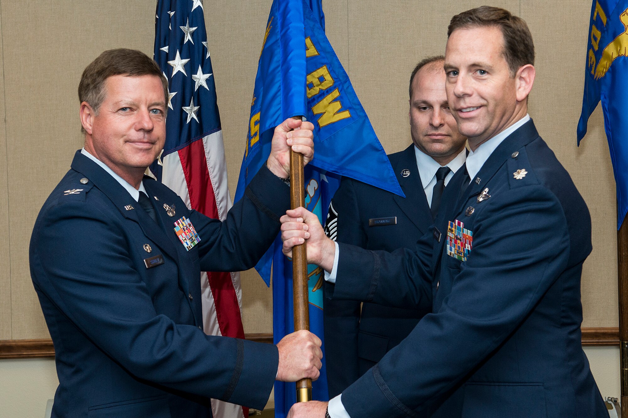 U.S. Air Force Lt. Col. Christopher Anderson (right) takes grip of the 307th Operations Support Squadron guidon during a Change of Command ceremony, Sept. 30, 2014, Barksdale Air Force Base, La. Anderson is the former Director of Operations for the squadron and is an instructor navigator on the B-52H Stratofortress. (U.S. Air Force photo by Master Sgt. Greg Steele/Released)