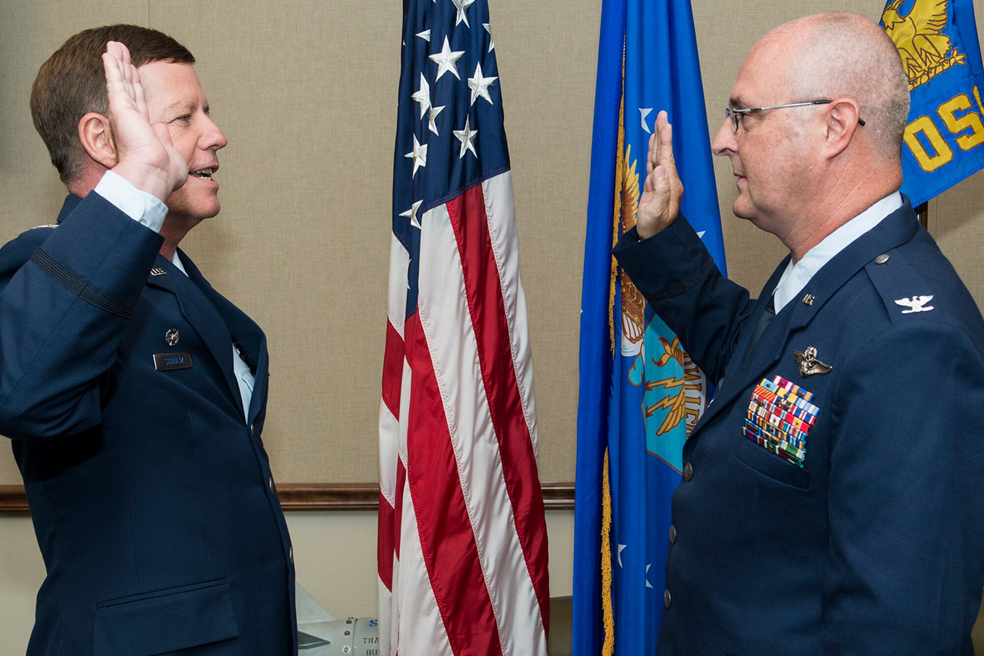 U.S. Air Force Col. Keith Schultz (left), 307th Operations Group commander, administers the Oath of Office to Col. David Webb during a promotion ceremony, Sept. 30, 2014, Barksdale Air Force Base, La. Webb is commander of the 307th Operations Support Squadron and was recently promoted to the rank of Colonel. (U.S. Air Force photo by Master Sgt. Greg Steele/Released)
