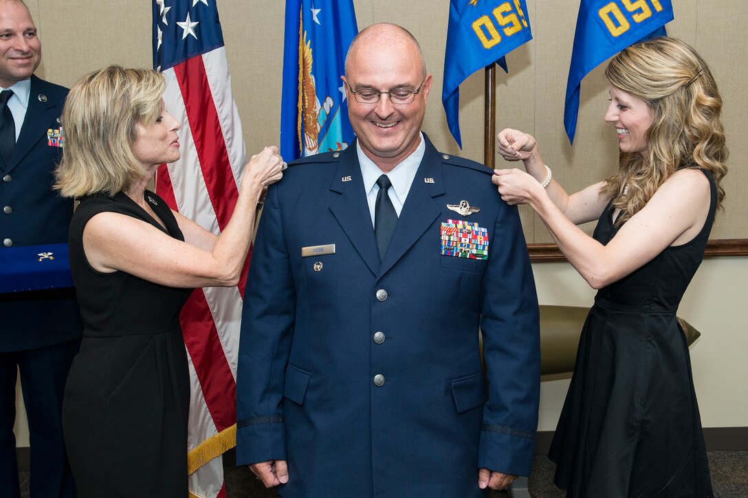 U.S. Air Force Col. David Webb is pinned by his wife Valli and daughter Savannah during a ceremony on Sept. 30, 2014, Barksdale Air Force Base, La. Webb is commander of the 307th Operations Support Squadron and was recently promoted to the rank of Colonel. (U.S. Air Force photo by Master Sgt. Greg Steele/Released)
