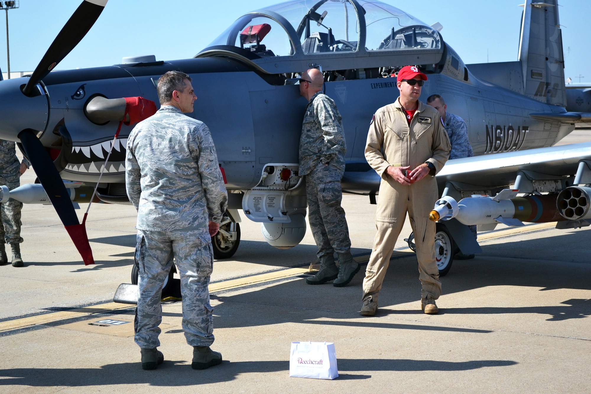 Service members inspect the AT-6 that was featured Sept. 18 on Will Rogers Air National Guard Base in Oklahoma City. (Official U.S. Air Force photo by Airman 1st Class Brigette Waltermire)