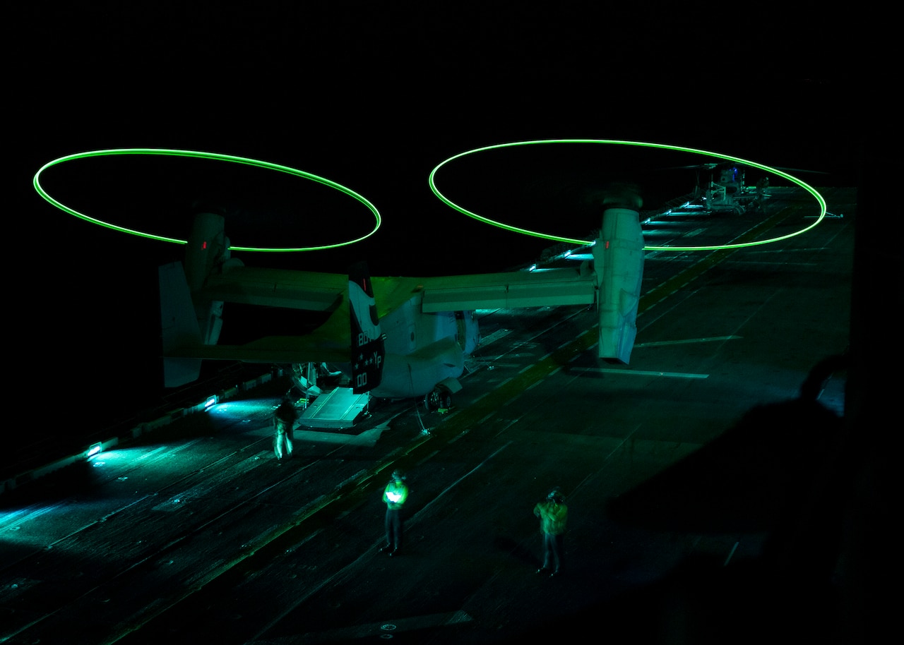 An MV-22 Osprey displays static lights while performing operational testing during night vision device flight operations aboard the amphibious assault ship USS Makin Island Sept. 18, 2014, while underway in the Persian Gulf. The lights make the rotors visible during nighttime takeoffs and landings. U.S. Navy photo by Petty Officer 3rd Class Robin W. Peak