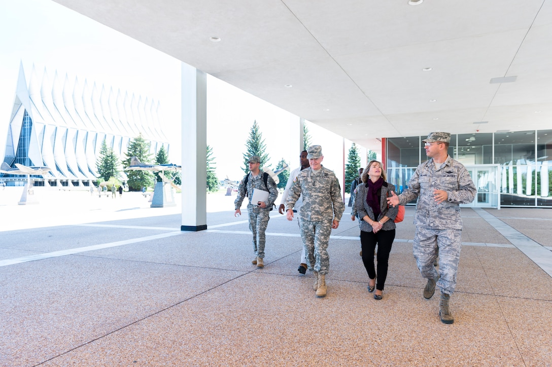 Air Force Academy Commandant Brig. Gen. Stephen Williams, right, escorts Army Gen. Martin E. Dempsey, chairman of the Joint Chiefs of Staff, left, and his wife, Deanie, during a visit to the U.S. Air Force Academy in Colorado Springs, Colo., Oct. 3, 2014. 