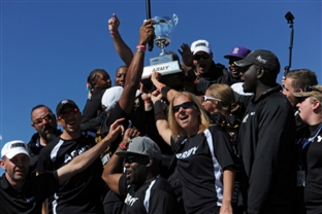Members of Team Army raise the Warrior Games Chairman’s Cup during a tailgate party for wounded warriors before the Navy vs. Air Force football game at the U.S. Air Force Academy in Colorado Springs, Colo., Oct. 4, 2014. The Chairman's Cup is presented to the top overall performing service branch at the week-long Warrior Games, which concluded on Oct. 3. The event brought together more than 200 wounded, injured and ill service members and veterans to compete in adaptive sports.