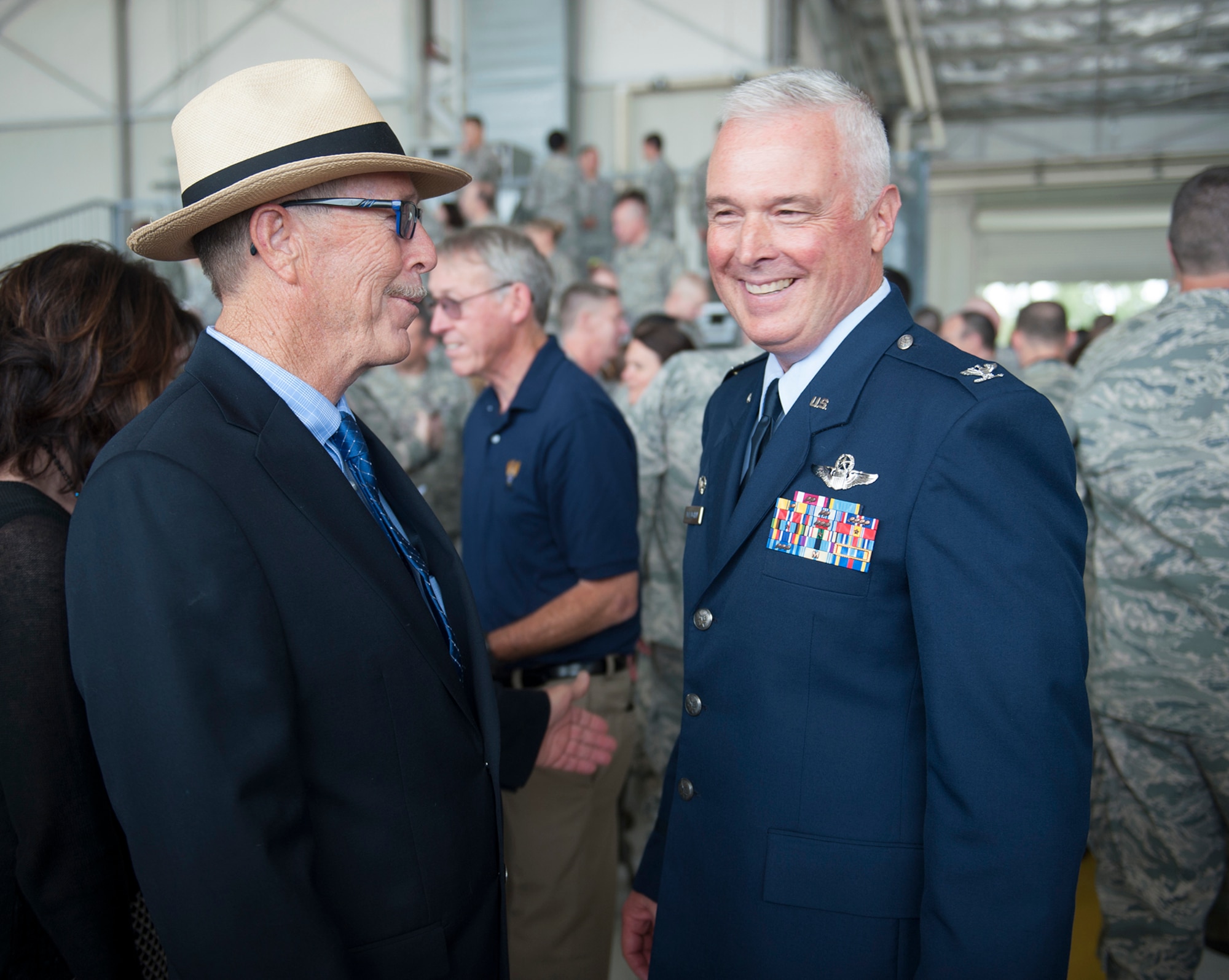 Col. Scott McLaughlin (right), 446th Airlift Wing commander, greets family and friends after the Assumption of Command ceremony Oct. 4 at Hangar 9. (U.S. Air Force Reserve photo Master Sgt Eliezer Yamzon)