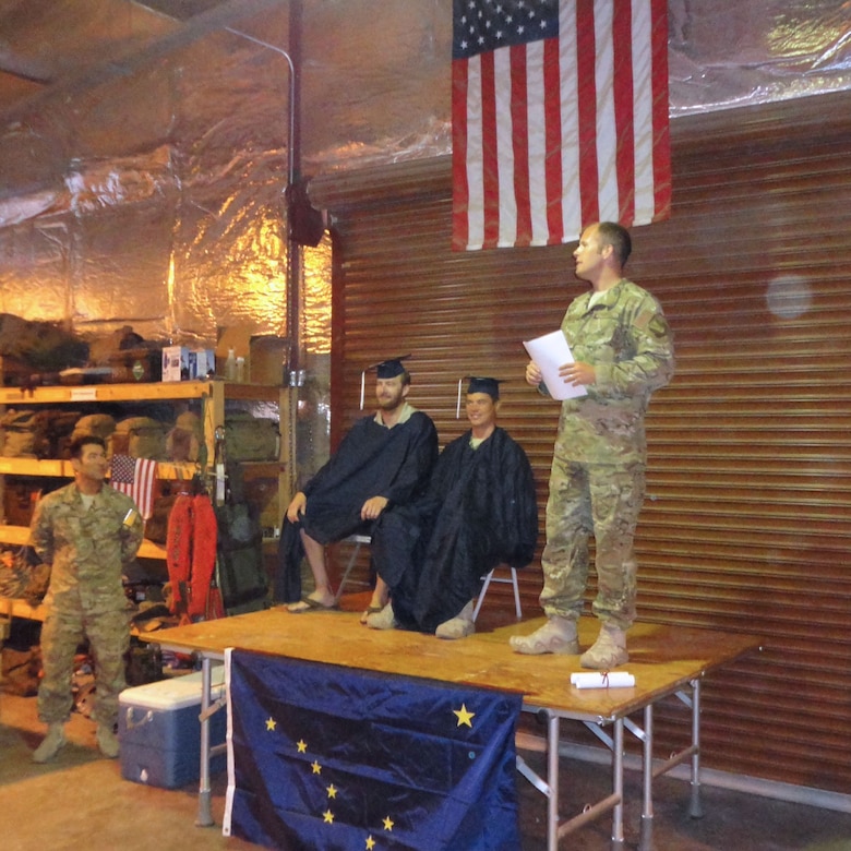 DJIBOUTI, Africa -- Chief Master Sgt. Paul Barendregt delivers the opening remarks at an intimate graduation ceremony here for deployed members, Master Sgt. Kris Abel and Staff Sgt. Nate Greene.(From l-r, Maj Komatsu, MSgt Kris Abel, SSgt Nate Greene, and CMSgt Paul Barendregt.)