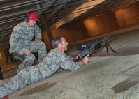 Col. Bryan Radliff, 419th Fighter Wing commander, listens to Staff Sgt. Jared Jeppsen, 419th Security Forces journeyman, give instruction before he fires a 249. (U.S. Air Force photo/Staff Sgt. Christina Judd)