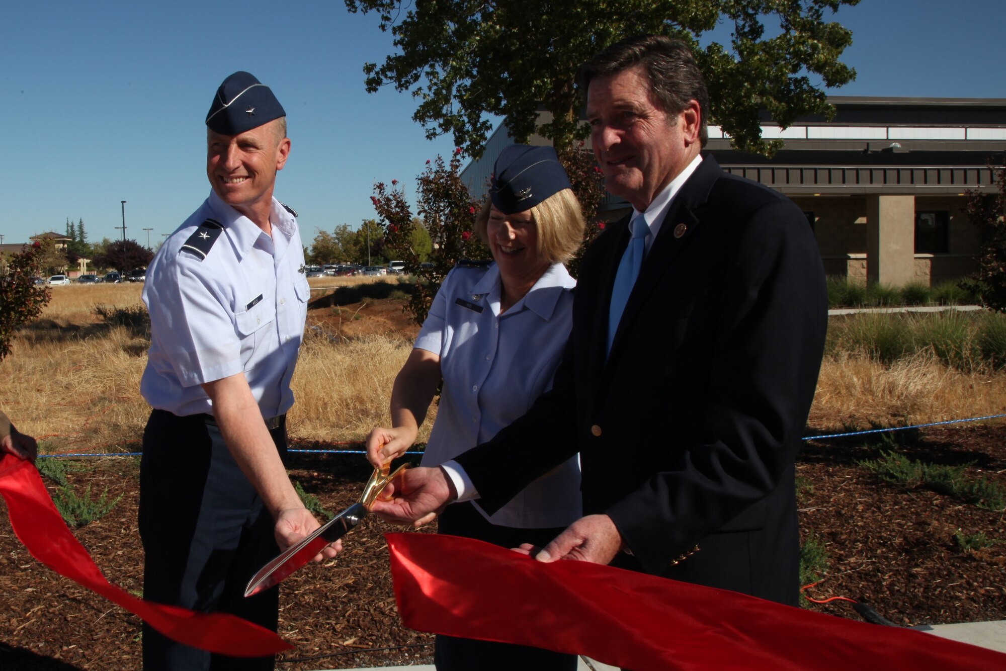 Brig. Gen. Jon Kelk, California Air National Guard commander, Col. Marilyn Rios, 162nd Combat Communications Group commander and Rep. John Garamendi, 3rd Congressional District cut the ribbon at the new 162nd Combat Communications Group headquarters,  Sept. 4, 2014 at Beale Air Force Base, Calif.  The building will save approximately $3.3 million dollars in costs over the next five years.  (U.S. Air Force photo by Tech. Sgt. Kenneth McCann/Released)