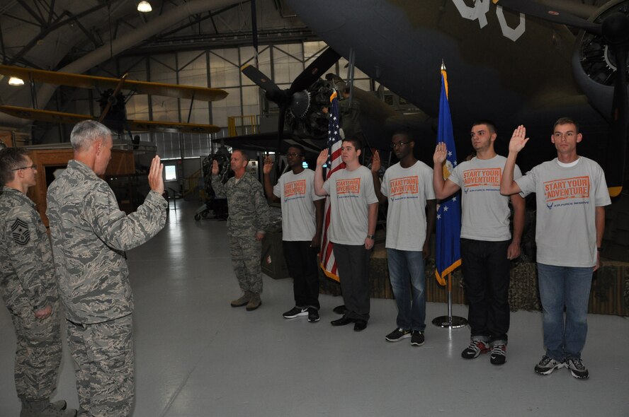 Col. J. Scott Hayes (second from left), 512th Airlift Wing vice commander, administers the oath of enlistment to five new recruits and one re-enlistee during a mass enlistment ceremony Oct. 4, 2014, at the Air Mobility Command Museum, Dover, Del. The new recruits ranged in age from 19 to 30 and have selected maintenance and operations career fields, including C-5 loadmaster and C-17 crew chief. (U.S. Air Force photo/Senior Airman Joe Yanik)
