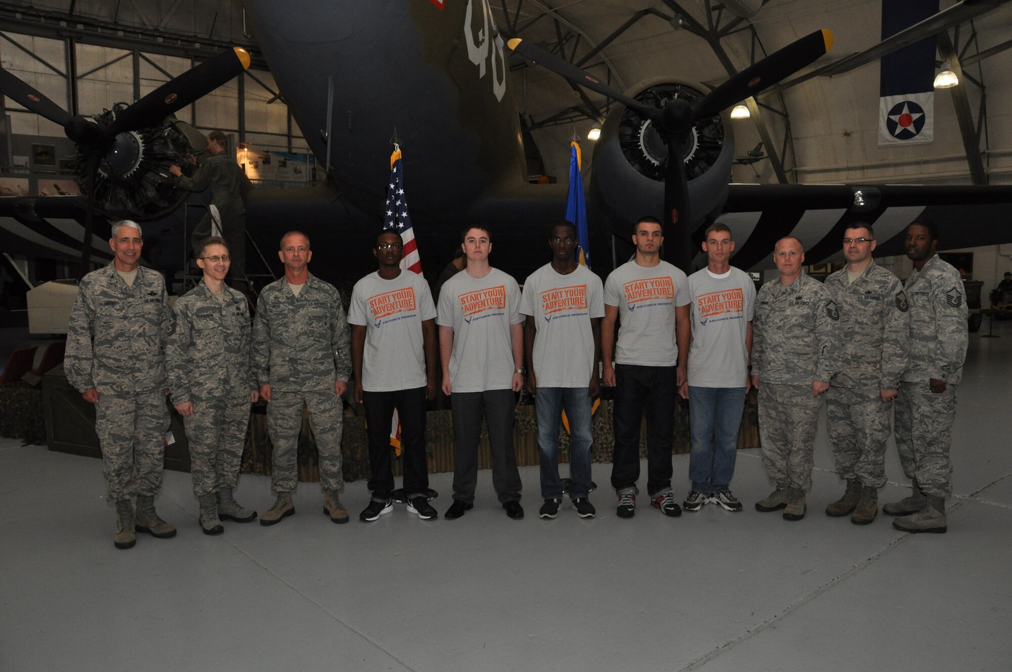 Col. J. Scott Hayes, 512th Airlift Wing vice commander (left) administered the oath of enlistment to five new recruits and one re-enlistee, from Delaware, Maryland and Virginia,  Oct. 4, 2014, during a mass enlistment ceremony at the Air Mobility Command Museum, Dover Air  Force Base, Del. Also present for the ceremony was the Chief Master Sgt. Brad E. Ferguson, 512t AW command chief (second from left) and Liberty Wing recruiters (right). (U.S. Air Force photo/Senior Airman Joe Yanik)