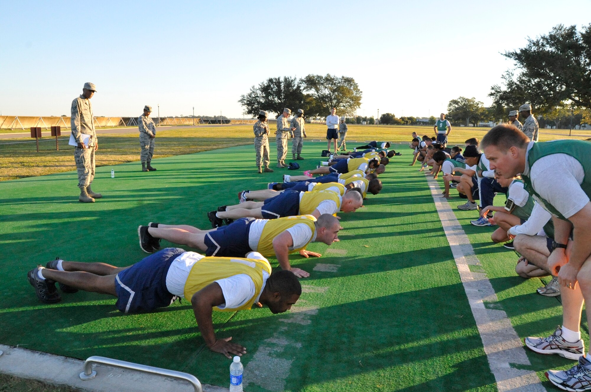 403rd Wing members perfom push-ups during the physical fitness testing during the October unit training assembly.   (U.S. Air Force photo/Master Sgt. Jessica L. Kendziorek)