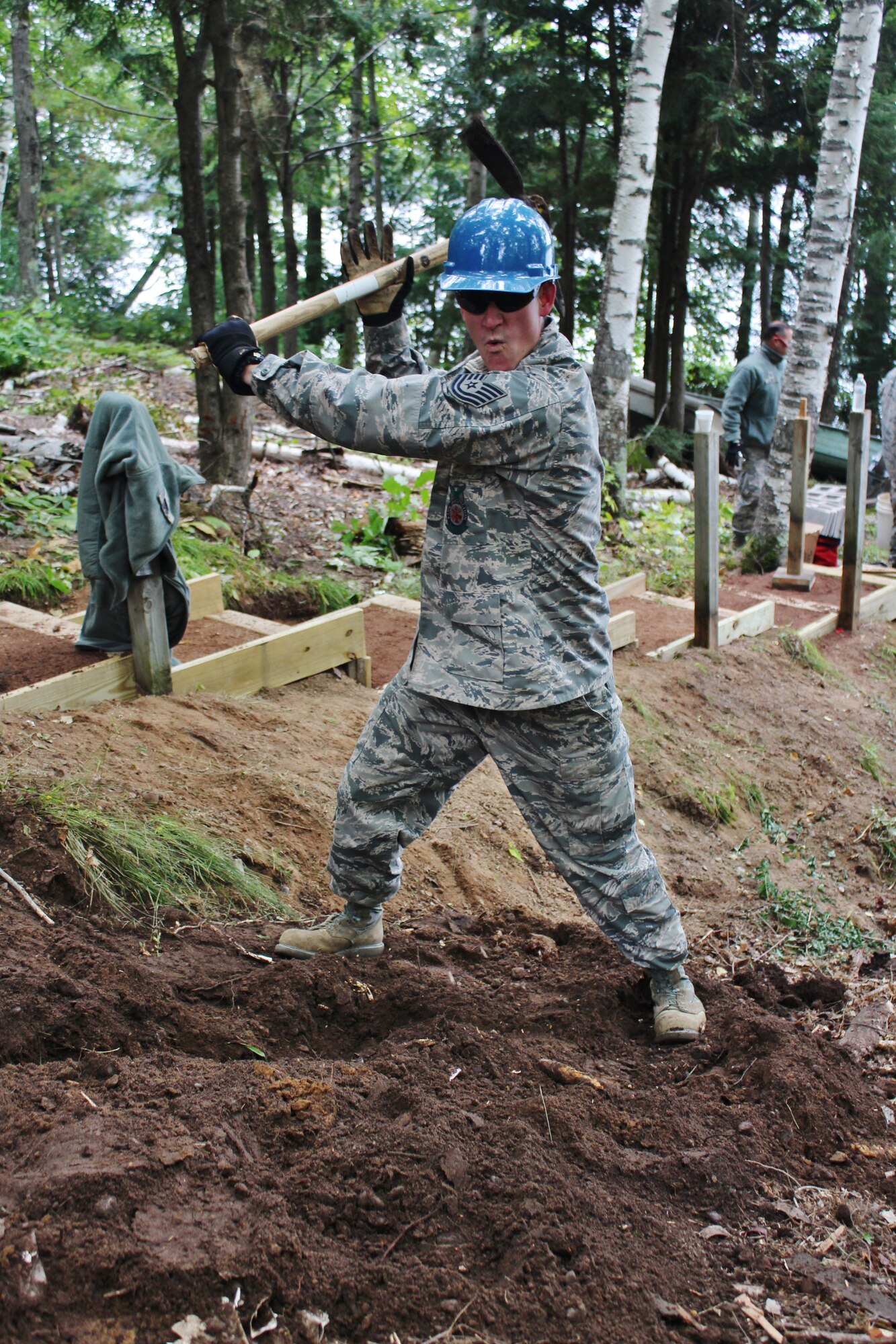 Tech. Sgt. Brandon Gumm, a firefighter with the 128th Air Refueling Wing, digs a trench for electrical wiring and plumbing during the renovation of a cabin at Camp American Legion in Lake Tomahawk, Wis. Sept. 18, 2014.  The civil engineering squadron with the 128th Air Refueling Wing, Wisconsin Air National Guard conducted hands-on training while renovating a cabin for Camp American Legion Sept 13-27, 2014. (U.S. Air National Guard photo by Staff Sgt. Josh Garringer/Released)