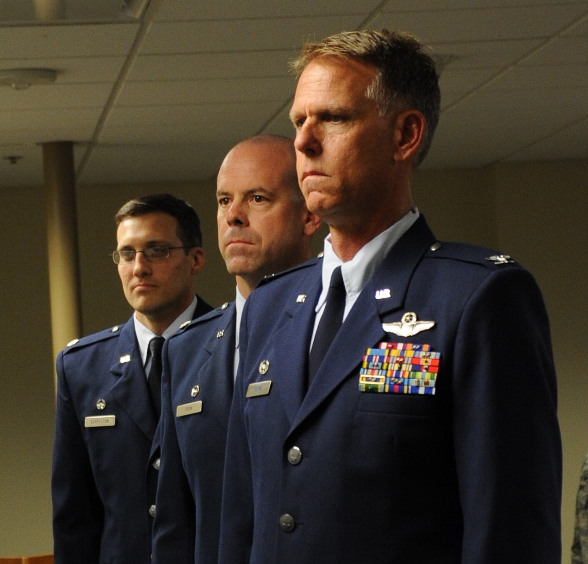 Col. Larry Shaw (right), Lt. Col. Kevin Prom (middle), and Lt. Col. Michael Stapleton (left) stand at attention while the National Anthem plays during a change of command ceremony for the 927th Operations Support Squadron Saturday, October 4. Lt. Col. Stapleton assumed command from Lt. Col. Kevin Prom, who served as the 927 OSS Commander for more than three years. (U.S. Air Force Photo/Adam C. Borgman)