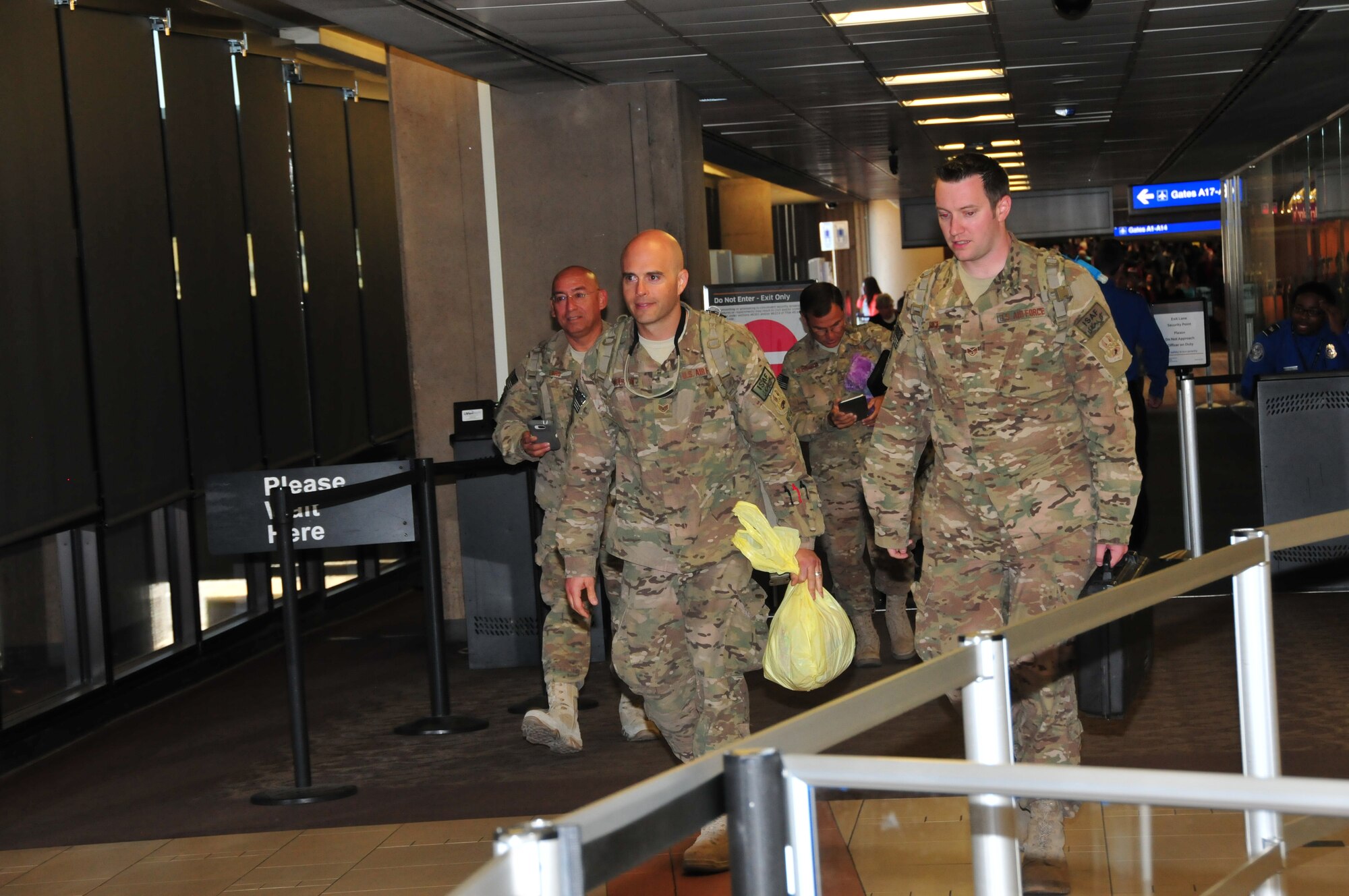 Master Sgt. Perry Toro, Staff Sgt. Michael Gunderson, Staff Sgt. Alfred Delaporta and Staff Sgt. David Rice of the 161st Air Refueling Wing Logistics Readiness Squadron are welcomed back to Arizona at the Phoenix Sky Harbor International Airport after their recent deployment, Oct. 3, 2014. Fourteen Airmen from the 161st ARW Aerial Port spent seven months in Afghanistan in support of Operation Enduring Freedom. (U. S. Air National Guard photo by Master Sgt. Kelly M. Deitloff/released)