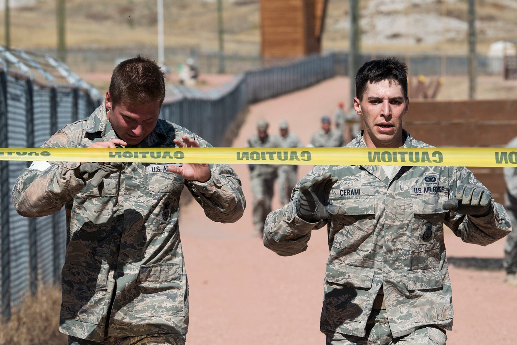 U.S. Air Force Staff Sgts. Johnathan Maupin and Robert Cerami reach for the finish line at the end of the Global Strike Challenge Mental and Physical competition, Sept. 25, 2014, Camp Guernsey, Wyo. The Global Strike Challenge is the world's premier bomber, Intercontinental Ballistic Missile, helicopter operations and security forces competition with units from Air Force Global Strike Command, Air Combat Command, Air Force Reserve Command and the Air National Guard. (U.S. Air Force photo by Master Sgt. Greg Steele/Released)