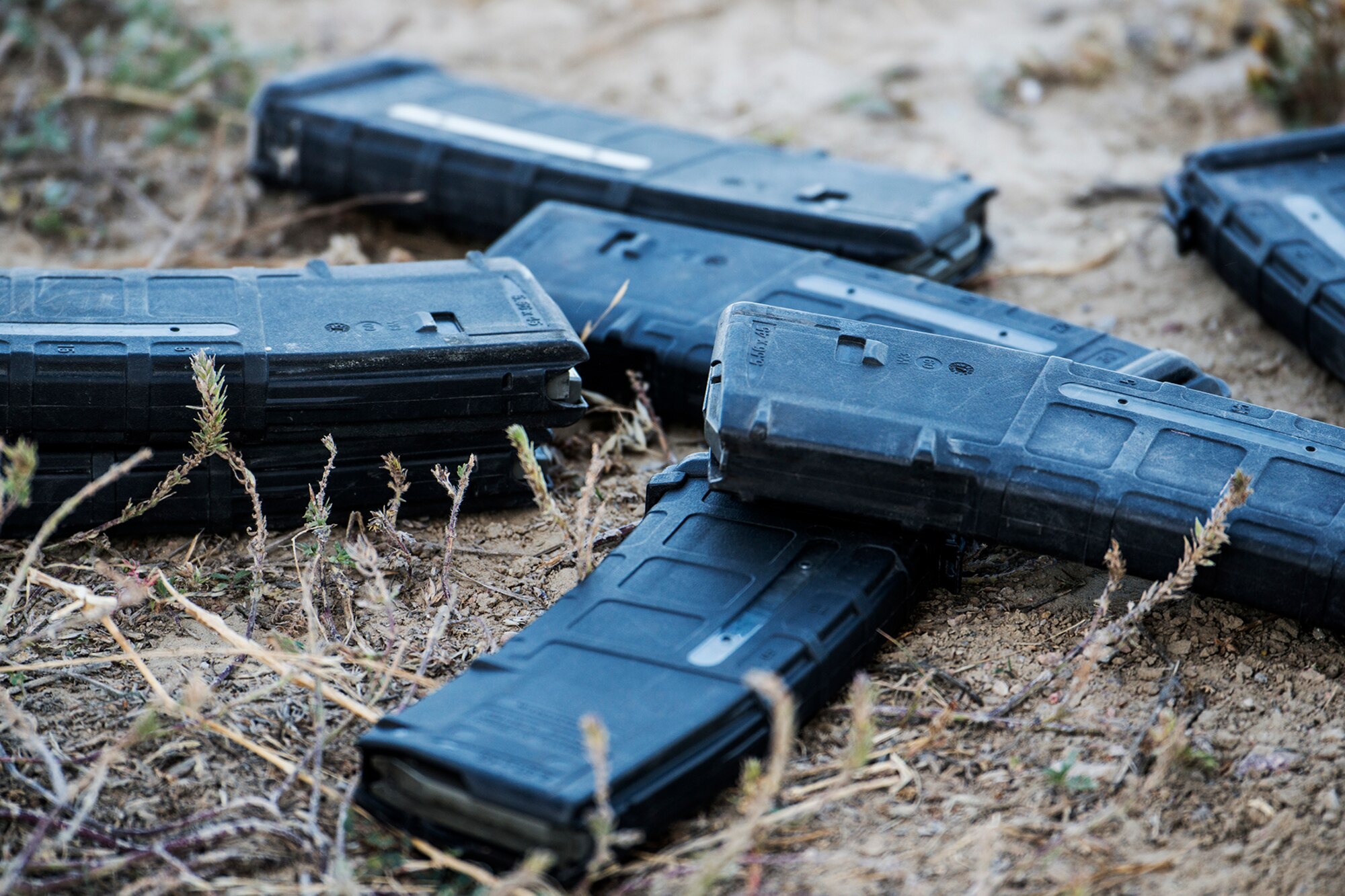 Empty 30 round 5.56 mm magazines litter the ground after the Global Strike Challenge Weapons Firing competition, Sept. 24, 2014, Camp Guernsey, Wyo. The Global Strike Challenge is the world's premier bomber, Intercontinental Ballistic Missile, helicopter operations and security forces competition with units from Air Force Global Strike Command, Air Combat Command, Air Force Reserve Command and the Air National Guard. (U.S. Air Force photo by Master Sgt. Greg Steele/Released)