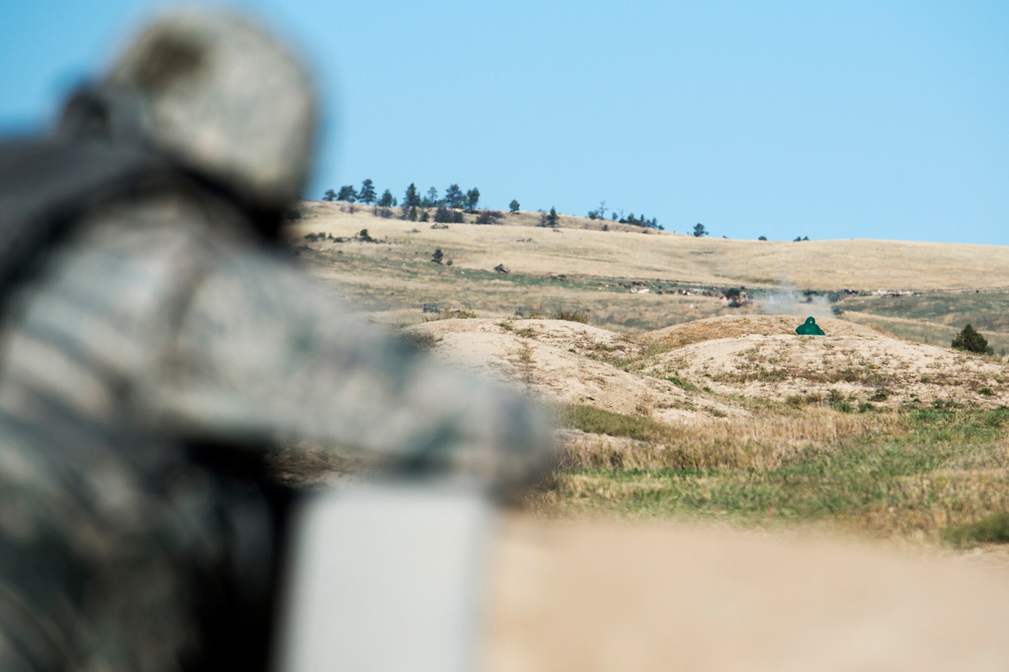 Dirt flies from the impacts of 5.56 mm bullets fired by a member of the 307th Security Forces Squadron during the Global Strike Challenge Weapons Firing competition, Sept. 24, 2014, Camp Guernsey, Wyo. The Global Strike Challenge is the world's premier bomber, Intercontinental Ballistic Missile, helicopter operations and security forces competition with units from Air Force Global Strike Command, Air Combat Command, Air Force Reserve Command and the Air National Guard. (U.S. Air Force photo by Master Sgt. Greg Steele/Released)