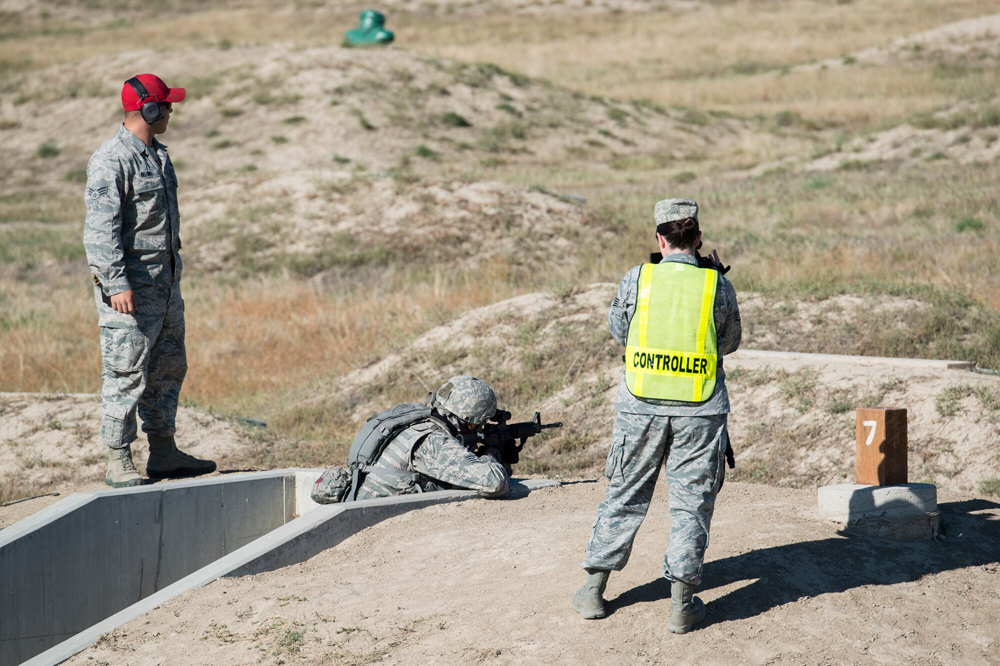 Observers watch as a member of the 307th Security Forces Squadron fires at targets during the Global Strike Challenge Weapons Firing competition, Sept. 24, 2014, Camp Guernsey, Wyo. The Global Strike Challenge is the world's premier bomber, Intercontinental Ballistic Missile, helicopter operations and security forces competition with units from Air Force Global Strike Command, Air Combat Command, Air Force Reserve Command and the Air National Guard. (U.S. Air Force photo by Master Sgt. Greg Steele/Released)
