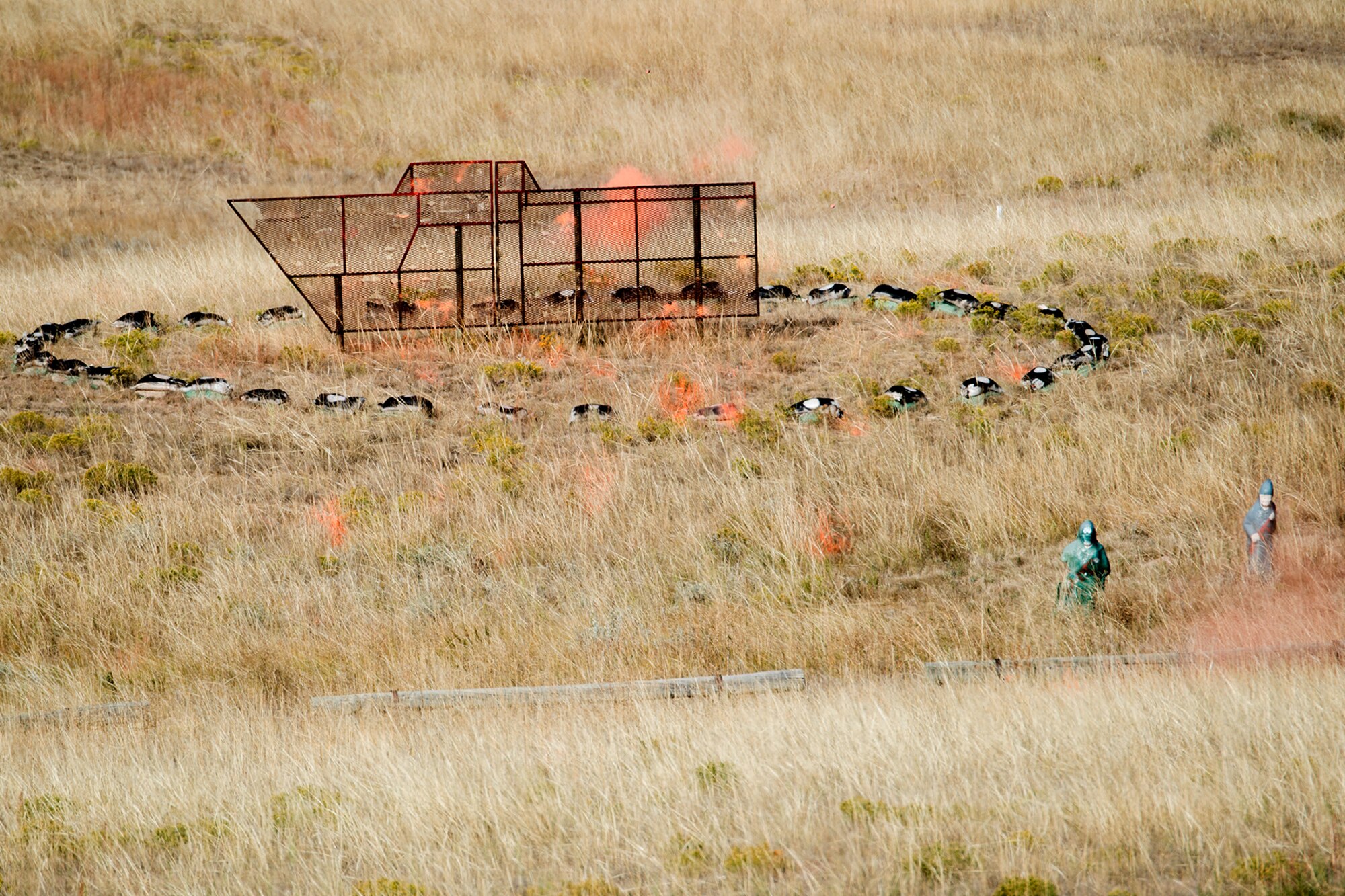 Orange smoke from an M203 grenade rises from the target impact area during the Global Strike Challenge Weapons Firing competition, Sept. 24, 2014, Camp Guernsey, Wyo. The Global Strike Challenge is the world's premier bomber, Intercontinental Ballistic Missile, helicopter operations and security forces competition with units from Air Force Global Strike Command, Air Combat Command, Air Force Reserve Command and the Air National Guard. (U.S. Air Force photo by Master Sgt. Greg Steele/Released)