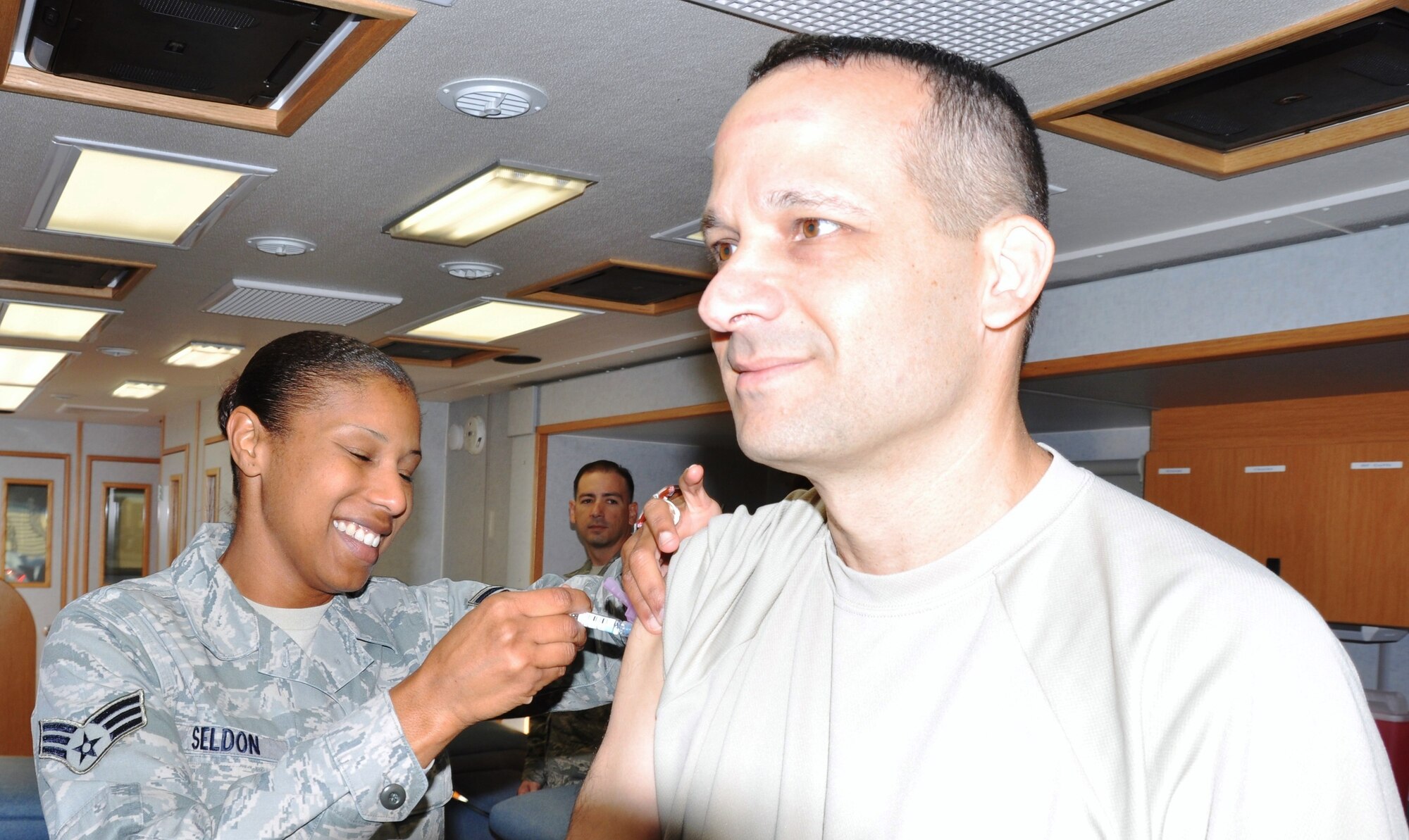 Senior Airman Latisha Seldon, a 433rd Aerospace Medicine Squadron medical technician, administers the flu vaccine to Chief Master Sgt. Brian M. Pinsky, 433rd Airlift Wing Command Chief, on Oct. 4, 2014 at Joint Base San Antonio-Lackland, Texas. (U.S. Air Force photo by Tech Sgt. Carlos J. Trevino)