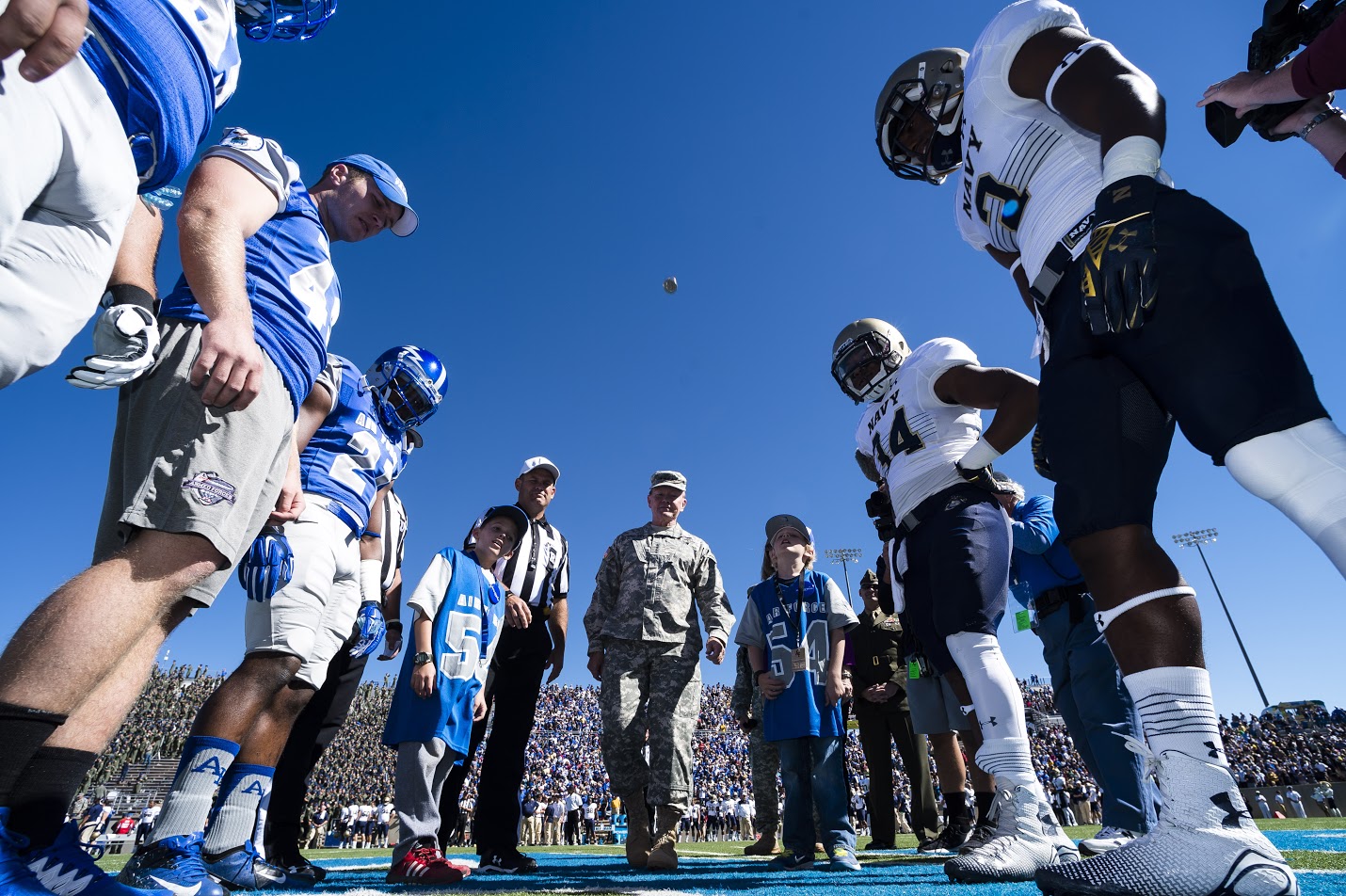 Members of the U.S. Air Force Academy and U.S. Naval Academy football teams  watch as Army