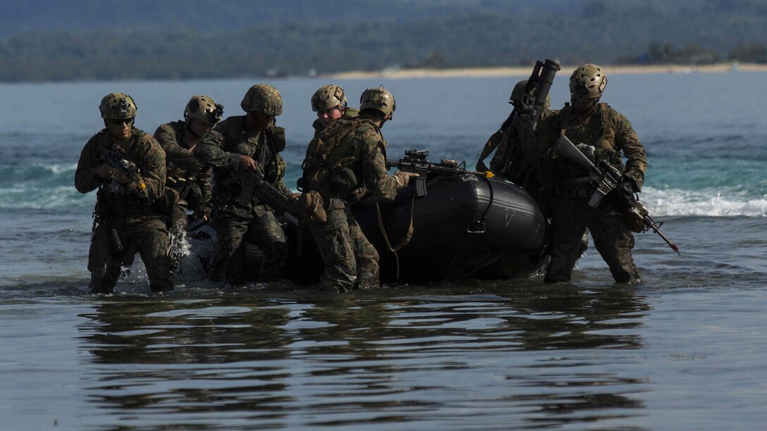 Philippine Marines with 12th Marine Battalion and U.S. Marines from Company L, Battalion Landing Team 3rd Battalion, 5th Marines, 31st Marine Expeditionary Unit, jump out of a combat rubber raiding craft during a simulated raid in support of Amphibious Landing Exercise 15 in Palawan, Philippines, October 2, 2014. PHIBLEX is an annual, bilateral training exercise conducted by the Armed Forces of the Philippines, U.S. Marines and Navy to strengthen interoperability across a range of capabilities to include disaster relief and contingency operations.