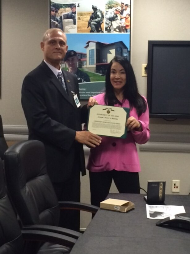 Jerry Boerste (left), receives Army Commanders Award for Civilian Service, presented by Karen Durham-Aguilera, Director of Contingency Operations (right). Boerste served as Chief, Operational Protection Division from 2009 to 2014.