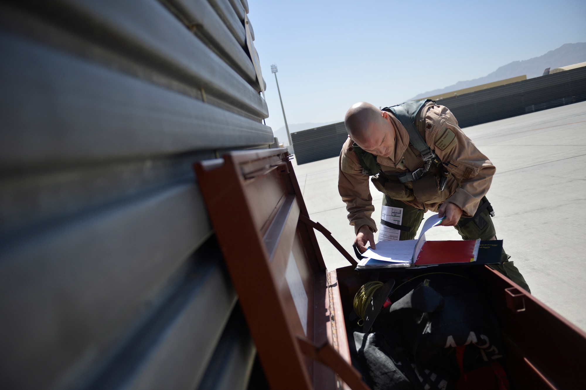 U.S. Air Force Maj. Vincent Sherer, 455th Ai r Expeditionary Wing, A-10 Thunderbolt II pilot, reviews a checklist before a sortie at Bagram Airfield, Afghanistan Aug. 5, 2014.  Sherer has been flying for 12 years and has deployed to Bagram four times.  He is deployed from Davis-Monthan Air Force Base, Ariz. and a native of Portland, Ore. (U.S. Air Force photo by Staff Sgt. Evelyn Chavez/Released)
