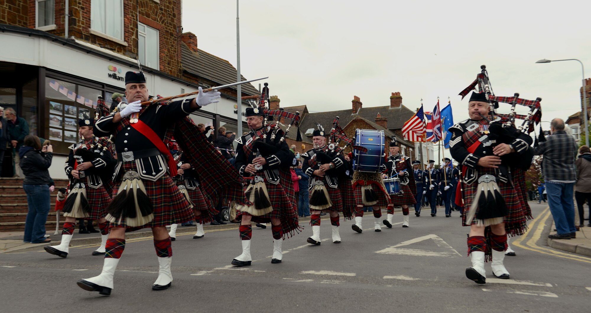 Led by the Norwich Pipe Band, members of the Team Mildenhall Honor Guard march in a parade Oct. 4, 2014, in Hunstanton, England. The parade serves to mark both the depth of Hunstanton’s gratitude and the strength of the relationship that has developed between the seaside town and the 67th Special Operations Squadron over the years. (U.S. Air Force photo/Airman 1st Class Preston Webb/Released)