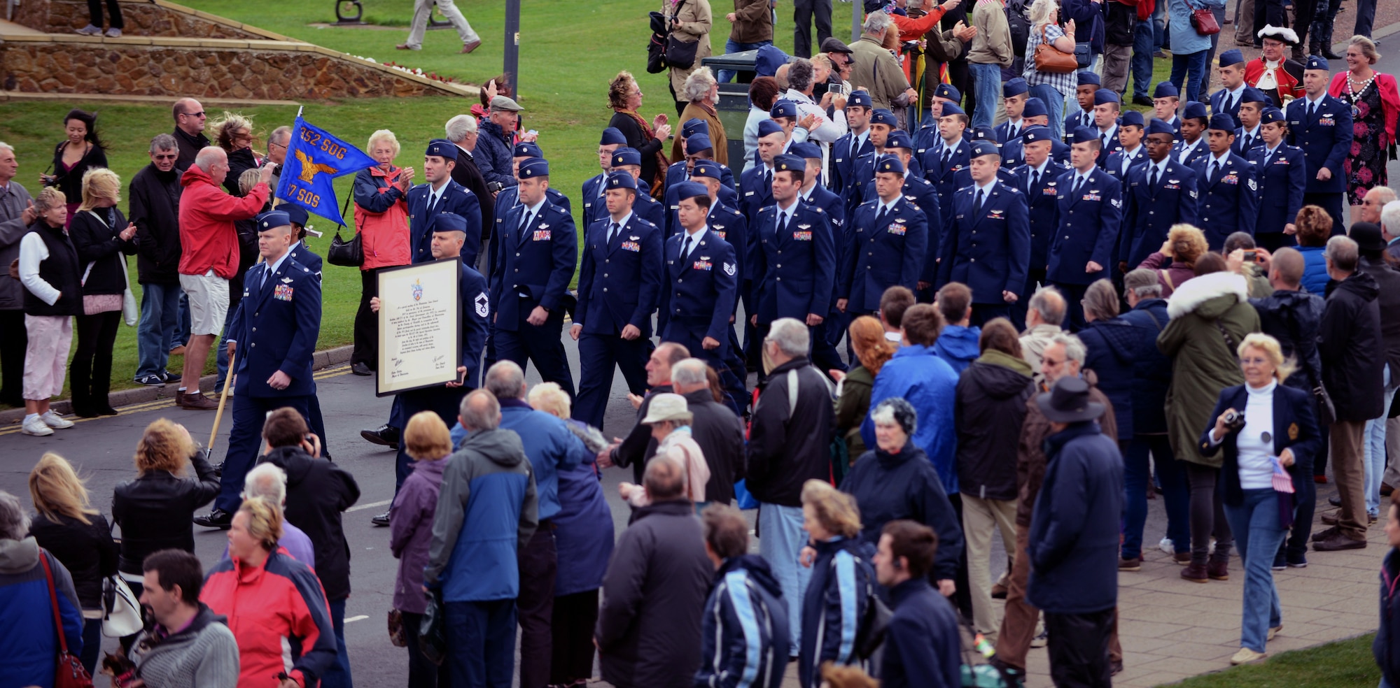 Airmen from the 67th Special Operations Squadron march in a parade after receiving the Freedom of Hunstanton, the highest award the town council is able to give, Oct. 4, 2014, in Hunstanton, England. The award was in commemoration of the lives saved by 67th Air Rescue Squadron Airmen during a flood in 1953. The town recognized the late Reis Leming in particular, who was an Airman 2nd Class at the time of the flood, for single-handedly saving 27 people. (U.S. Air Force photo/Airman 1st Class Preston Webb/Released)