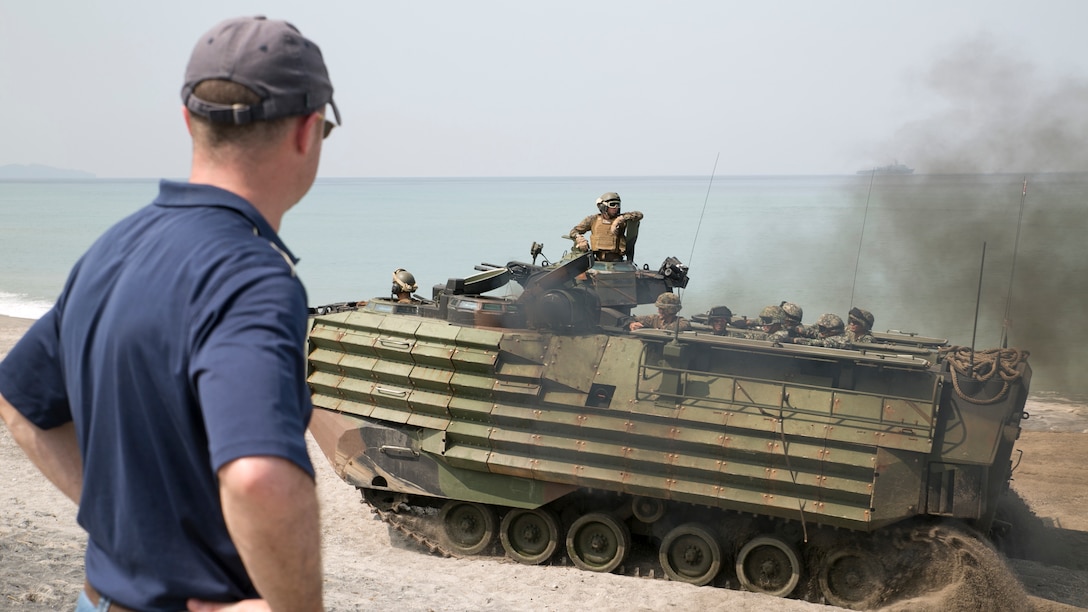 Barrett O. Comiskey watches as his brother rides inside an Amphibious Assault Vehicle during a mechanized assault that was part of Amphibious Landing Exercise 15 here, Oct. 5. Barrett traveled with his family from Taipei, Taiwan to the Philippines to surprise his brother after not seeing each other for over a year. His brother, 1st Lt. William D. Comiskey is an Amphibious Assault Vehicle platoon commander with Company I, Battalion Landing Team 3rd Battalion, 5th Marines, 31st Marine Expeditionary Unit. PHIBLEX is an annual, bilateral training exercise conducted by members of the Armed Forces of the Philippines alongside U.S Marine and Navy forces. (U.S. Marine Corps photo by Staff Sgt. Joseph DiGirolamo)