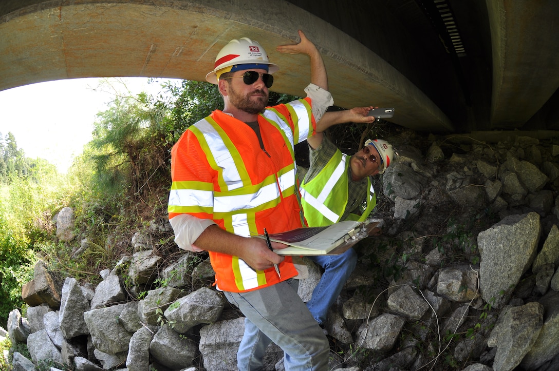 Jeremy Miller, 542nd Engineer Detachment Forward Engineering Support Team - Advanced (FEST-A) civil engineer, conducts a visual survey of a bridge located at Hunter Army Air Field as part of a bridge reconnaissance exercise held Sept. 18. FEST-A members gathered Sept. 15-25 to conduct two weeks of FEST-A field exercises. The team is seeking qualified members to fill structural, civil, topographer and electrical engineering positions (USACE photo by Chelsea Smith).