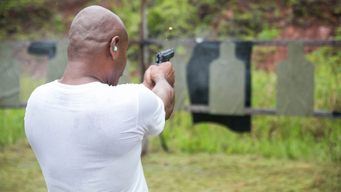 A Palauan national police officer fires the M9A1 9 mm service pistol during bilateral live-fire training Sept. 16 with U.S. Marines in Irai, Palau. Marines instructed the national law enforcement officers on the operations of the weapon, enhancing their fundamentals and strengthening relations between Palau and the U.S. The training is part of exercise T-AKE 14-2, a maritime pre-positioned force, multi-country theater security cooperation event that deploys from Okinawa aboard the USNS Sacagawea to conduct training exercises. 