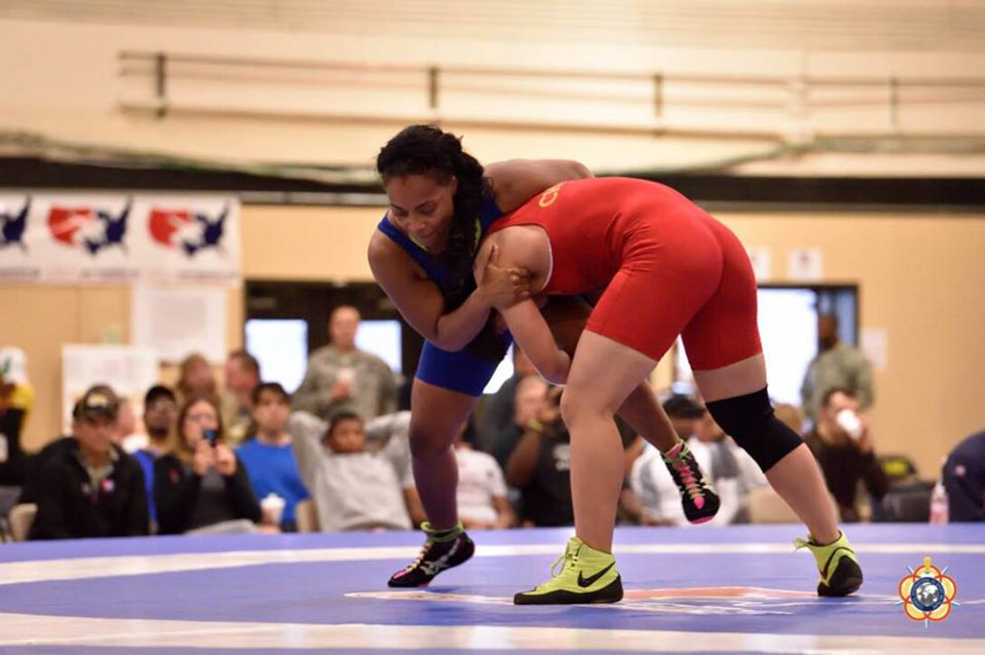 Army Staff Sgt. Iris Smith (blue) during her bronze medal performance during the Women's Freestyle 75kg competition at the 29th CISM World Military Wrestling Championship at Joint Base McGuire-Dix-Lakehurst, New Jersey 1-8 October 2014