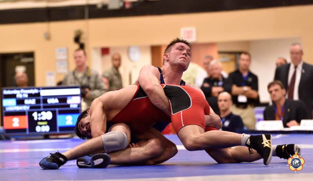 Army Sgt. Moza Fay (blue) turns his opponent during his silver medal performance of the 74kg competition at the 29th CISM World Military Wrestling Championship at Joint Base McGuire-Dix-Lakehurst, NJ 1-8 October 2014.
