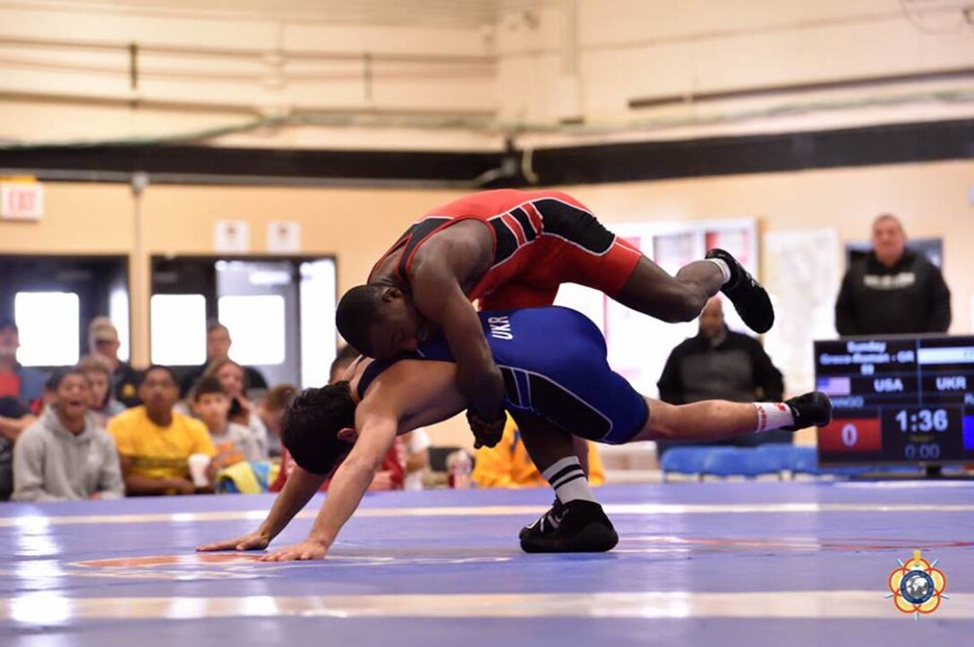 Army Sgt. Spencer Mango (red) prepares to throw his opponent during the 59kg Greco-Roman competition at the 29th CISM World Military Wrestling Championship at Joint Base McGuire-Dix-Lakehurst, NJ 1-8 October 2014.
