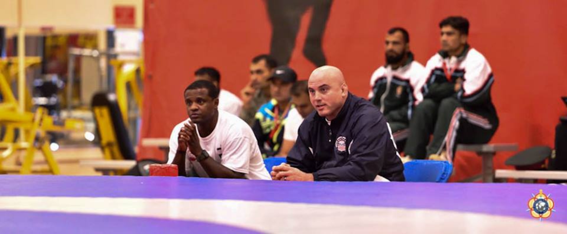 Assist Coach Gunnery Sgt. James Shillow (left) and Mr. Jason Loukides watch during the Greco-Roman competition at the 29th CISM World Military Wrestling Championship at Joint Base McGuire-Dix-Lakehurst, New Jersey 1-8 October 2014