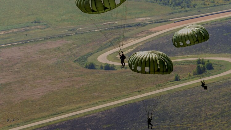 Critical skills operators with Marine Corps Forces Special Operations Command drift toward the ground after a bilateral static-line jump and Container Delivery System drop near Memphis, Tenn., Sept. 29, 2014. Marine Aerial Refueler Transport Squadron 252 Marines provided support for the MARSOC Marines’ long-range raid exercise.