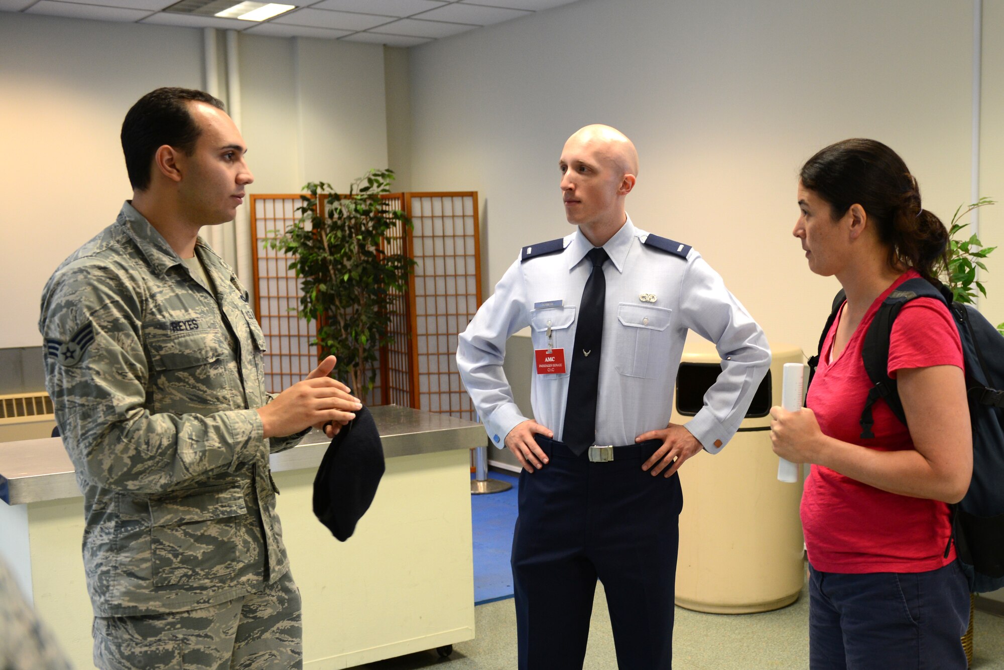 Senior Airman Nestor Reyes, 374th Security Forces Squadron customs and immigration agent, responds to questions at the 730th Air Mobility Squadron open house at Yokota Air Base, Japan, Sept. 29, 2014. More than 75 base personnel attended the event. (U.S. Air Force photo by Airman 1st Class David C. Danford/Released)