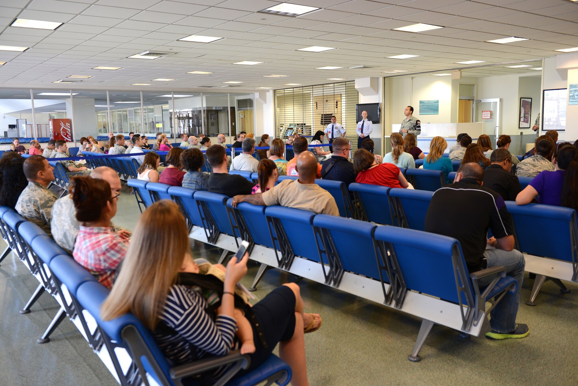 Senior Airman Nestor Reyes, 374th Security Forces Squadron customs and immigration agent, briefs at the 730th Air Mobility Squadron open house at Yokota Air Base, Japan, Sept. 29, 2014.  More than 75 base personnel attended the event. (U.S. Air Force photo by Airman 1st Class David C. Danford/Released)