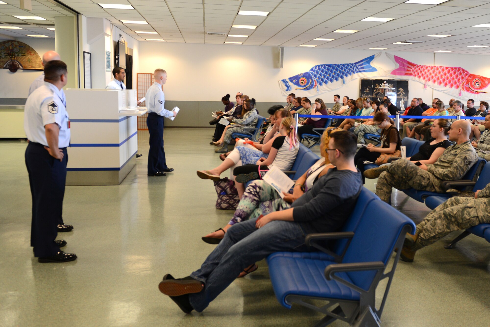 Airman 1st Class Tanner Salmonson, 730th Air Mobility Squadron passenger service agent, answers questions at the 730 AMS open house at Yokota Air Base, Japan, Sept. 29, 2014. The open house provided Airmen, dependents and Department of Defense civilians with the opportunity to learn about the programs available from the 730th. (U.S. Air Force photo by Airman 1st Class David C. Danford/Released) 