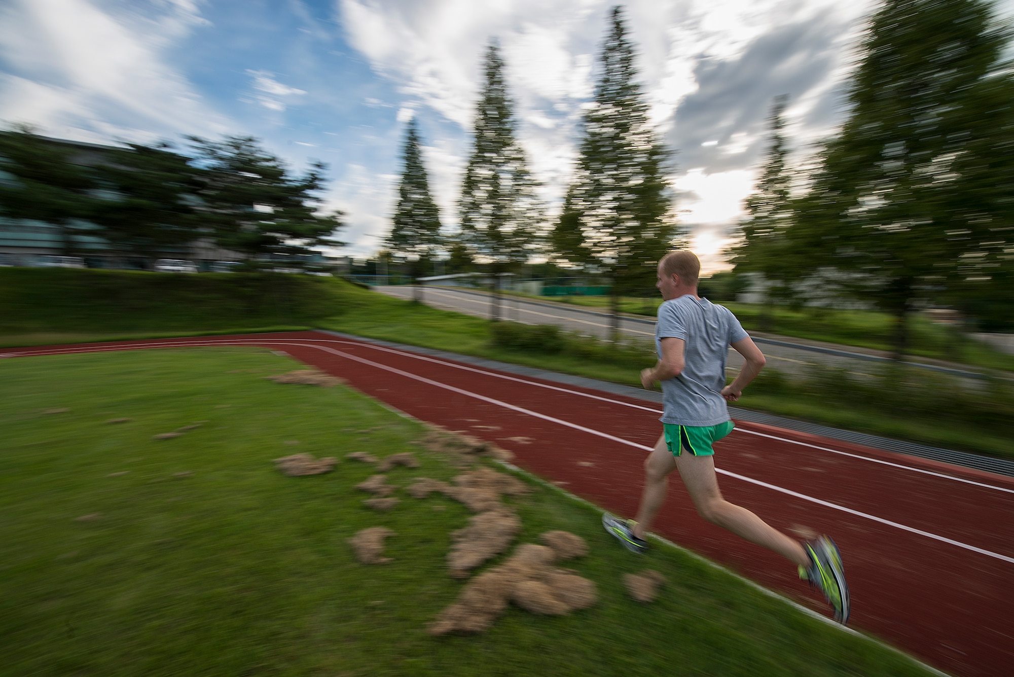 Airman 1st Class Andrew Riesenberger, a 51st Civil Engineer Squadron engineering technician, runs around the soccer field Sept. 9, 2014, at Osan Air Base, Republic of Korea. Riesenberger embraces the competetive nature of running, crediting the constant challenge of trying to be the best with inspiration to keep racing. (U.S. Air Force photo by Staff Sgt. Jake Barreiro/Released)