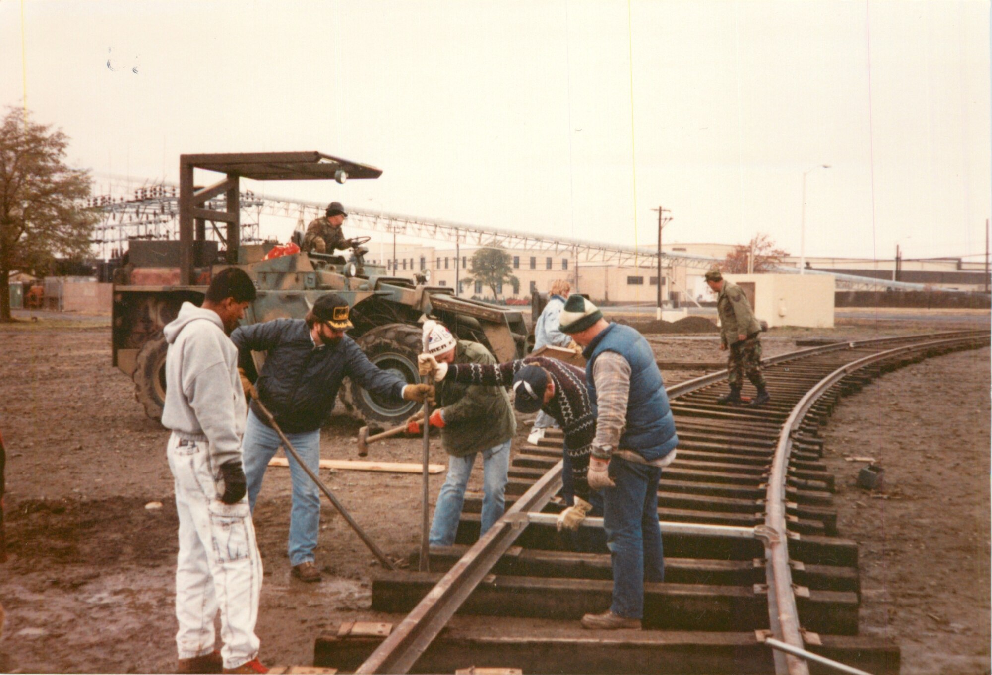 Operation Cannonball- Construction workers lay tracks southeast of building 2245 in 1990, the current home of the 92nd Comptroller Squadron at Fairchild Air Force Base, Washington. (U.S. Air Force photo)