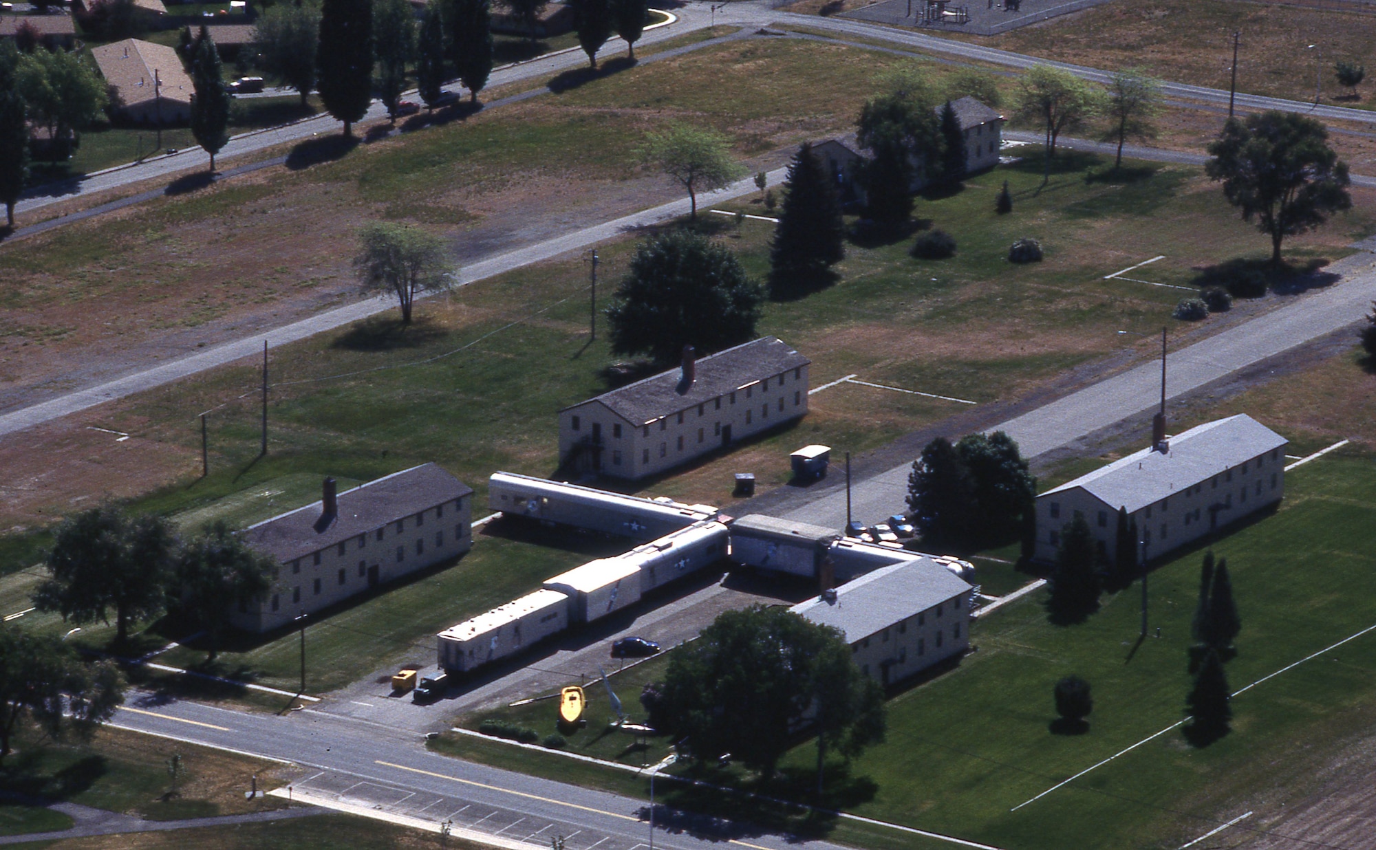 The Heritage Museum and Strategic Air Command B-52 Stratofortress and KC-135 Stratotanker simulator cars are seen while looking southeast at Fairchild Air Force Base, Washington, in 2002. Today, the museum buildings are gone. (U.S. Air Force photo)