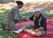 Airman First Class Casilda Scott, 940th Aerospace Medicine Squadron medical technician, examines 'patient' Robert Landgraf's simulated cut arm, at the squadron's annual Mass Casualty Exercise, Oct. 5, 2014, Beale Air Force Base, Calif. Landgraf, a retired colonel and former 940th AMDS commander, played a distressed patient that tried to distract the teams from helping the more seriously wounded patients. Involving the mentally traumatized 'patients' helped mimic as realistic of an emergency environment as possible. (U.S. Air Force photo by Tech. Sgt. Heather Skinkle/Released)
