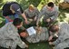 A team of 940th Aerospace Medicine Squadron members arrange Tech. Sgt. Joyce Satterfield, an optometry technician and simulated patient exhibiting blood loss, on a litter during a Mass Casualty Exercise, Oct. 5, 2014, Beale Air Force Base, Calif. Barbara Boyer, a retired lieutenant colonel and former 940th AMDS chief nurse, instructs the litter team on how to properly arrange the litter straps so as not to further injure the 'patient.' Boyer, along with other retired medical personnel, served as evaluators and patients to provide their expertise during the exercise. (U.S. Air Force photo by Tech. Sgt. Heather Skinkle/Released)