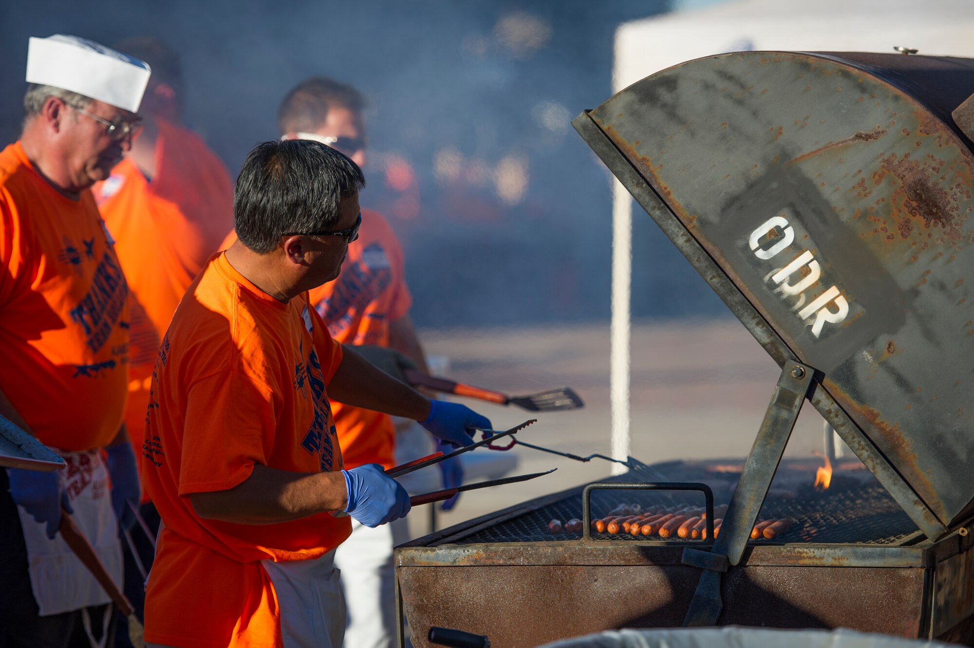 Volunteers from around the local community serve food to members of Team Holloman in the unaccompanied airman dormitory courtyard during the annual Thanks Team Holloman event at Holloman Air Force Base, N.M., Oct. 3. The annual event is hosted by civic leaders, the Committee of 50, and local businesses from Alamogordo to show their appreciation to the hundreds of Holloman members that attended. (U.S. Air Force photo by Airman 1st Class Aaron Montoya / Released)