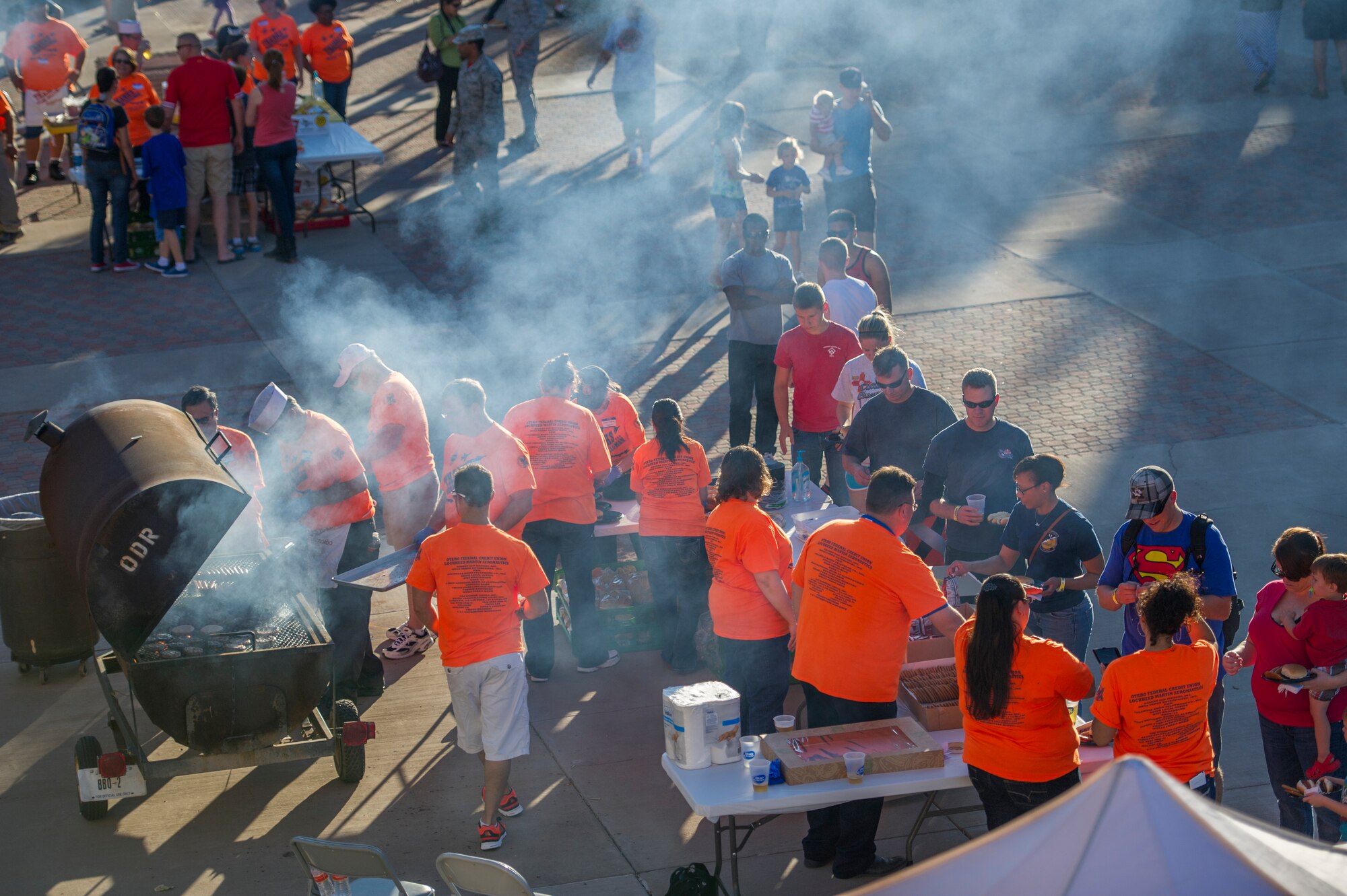 Volunteers from the around Tularosa Basin serve food to members of Team Holloman in the unaccompanied airman dormitory courtyard during the annual Thanks Team Holloman celebration at Holloman Air Force Base, N.M., Oct. 3. The annual event is hosted by civic leaders, the Committee of 50, and local businesses from Alamogordo to show their appreciation to the hundreds of Holloman members that attended. (U.S. Air Force photo by Airman 1st Class Aaron Montoya / Released)