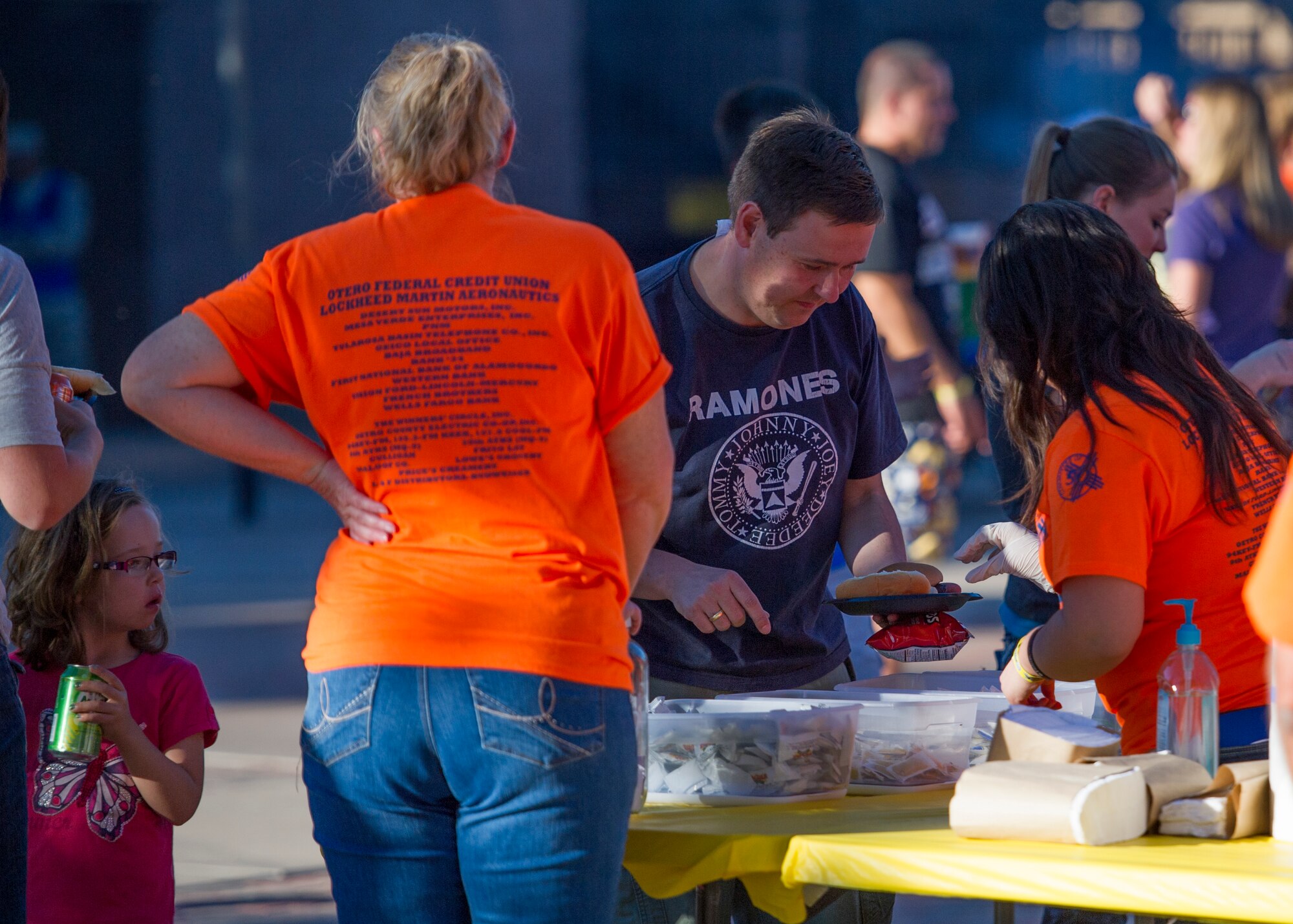 Volunteers from the around Tularosa Basin serve food to members of Team Holloman in the unaccompanied airman dormitory courtyard during the annual Thanks Team Holloman celebration at Holloman Air Force Base, N.M., Oct. 3. The annual event is hosted by civic leaders, the Committee of 50, and local businesses from Alamogordo to show their appreciation to the hundreds of Holloman members that attended. (U.S. Air Force photo by Airman 1st Class Aaron Montoya / Released)